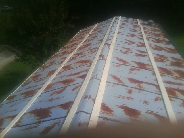 Rusted metal roof panels with new wood purlins before replacement — Storm Damage Roof Repair in Fairborn by Roofing Brothers