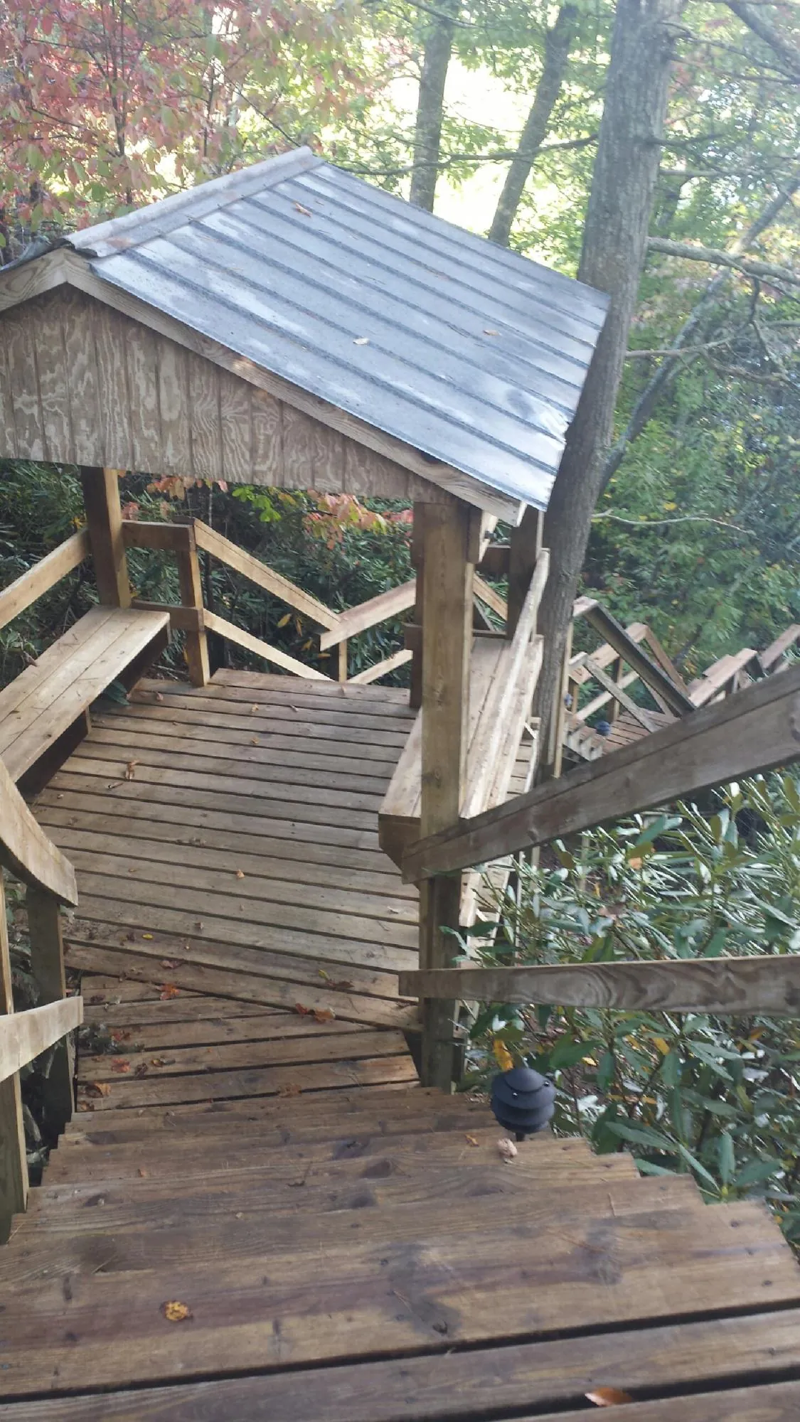 Metal roofed shelter over wooden steps on a wooded walkway — Skylight Repair & Installation work by our crew in Fairborn