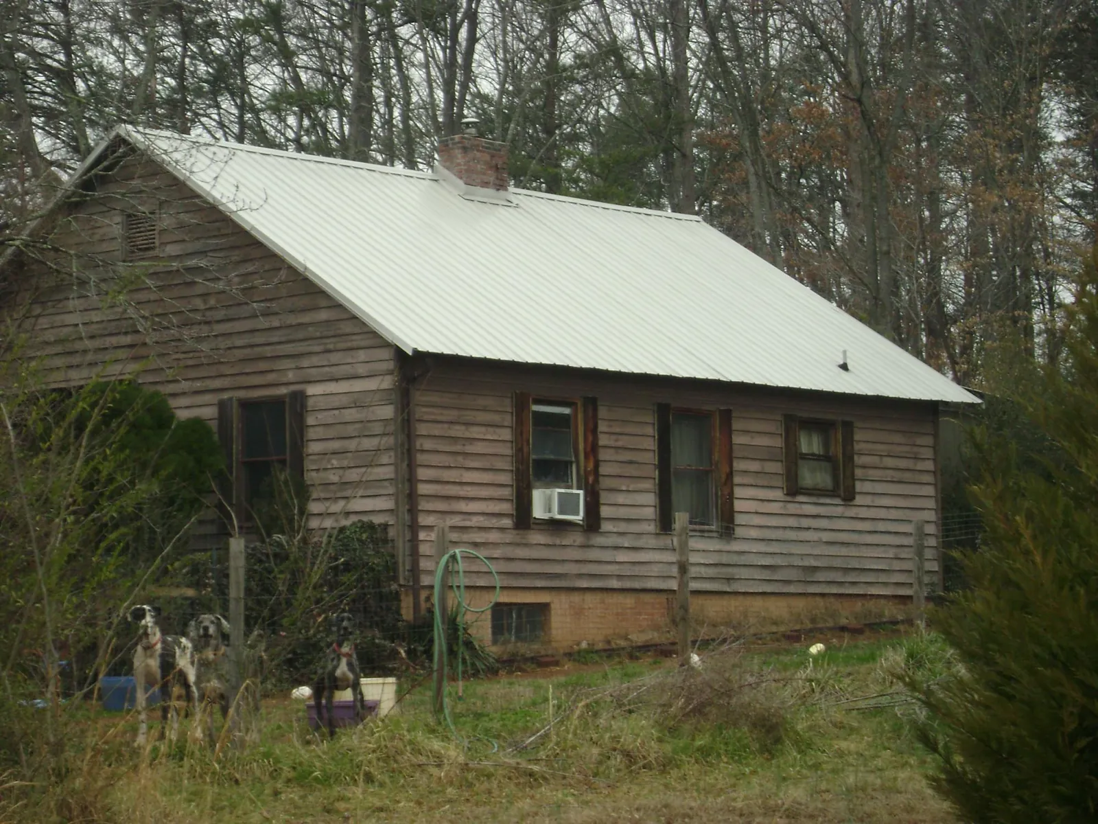 White metal roof on an old wood sided farmhouse, from a Metal Roof Installation job in Fairborn
